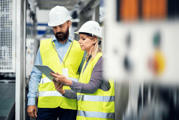 Two manufacturing workers wondering what is a CMMS