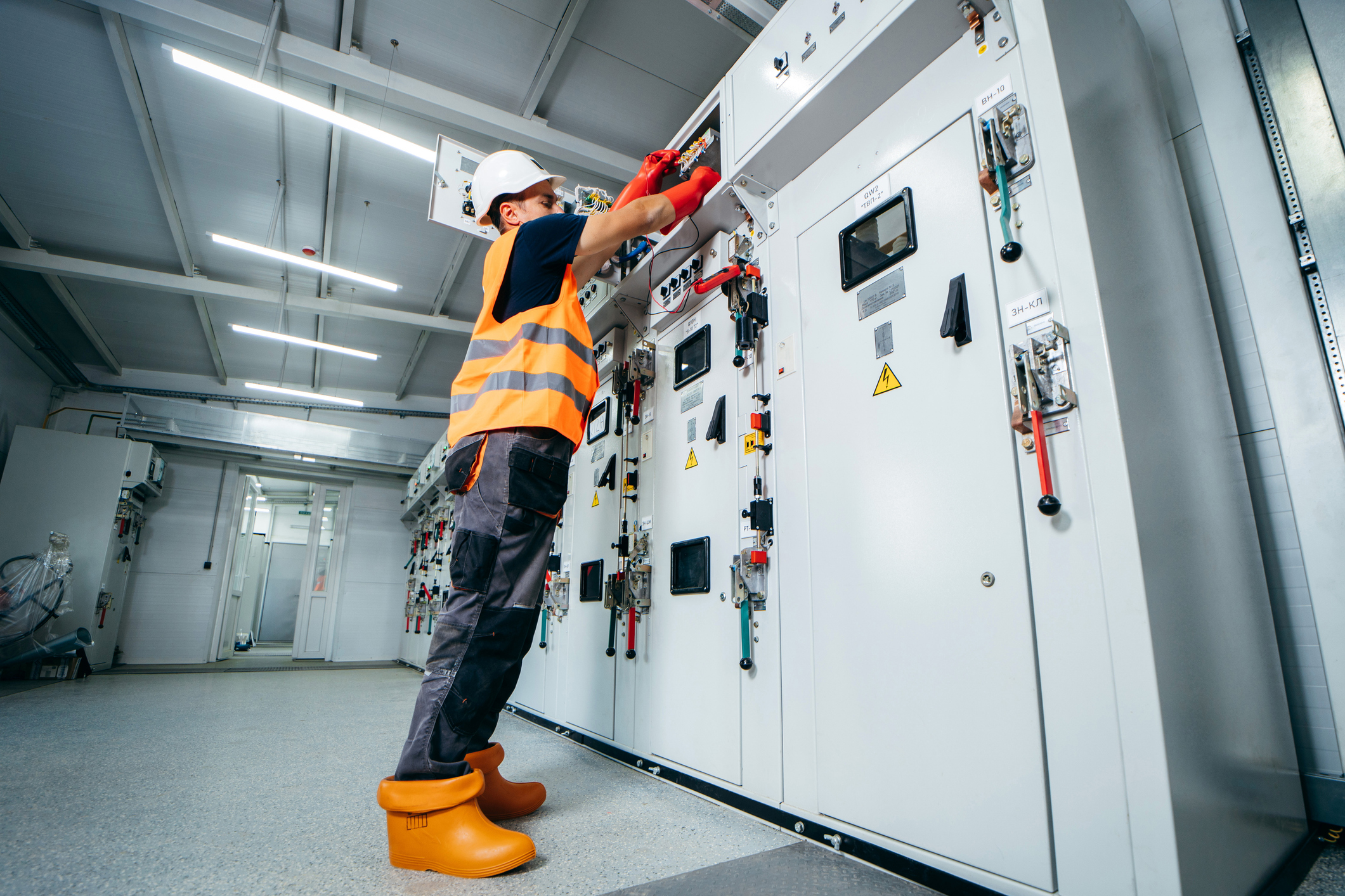 Electrical contractor performing NFPA 70B compliance inspection on industrial equipment